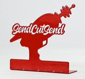 Image of a laser cut cold rolled steel decorative laser gun silhouette powder coated in red