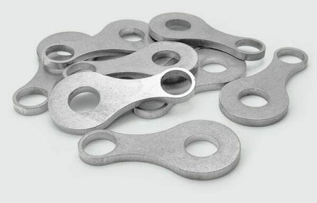 Image of 9 small laser cut products in aluminum