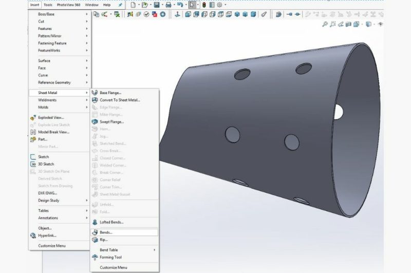 Screenshot showing the sheet metal toolbar in Solidworks, with the "Bends" feature highlighted. The 3D model of the aluminum rolled hopper is in the background.