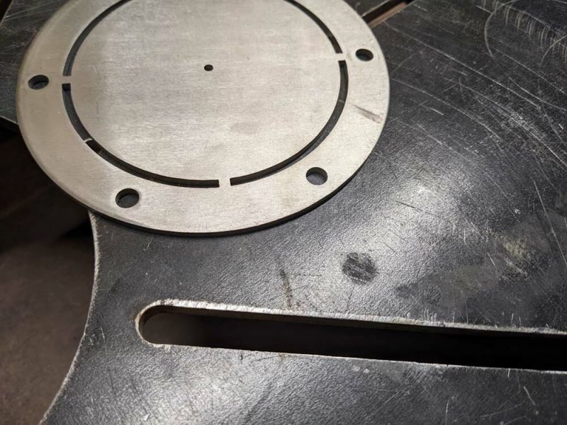 Image of a 304 Stainless Steel part sitting on top of a Hot Rolled jig plate.